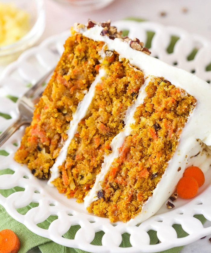 Slice of layered carrot cake with cream cheese frosting