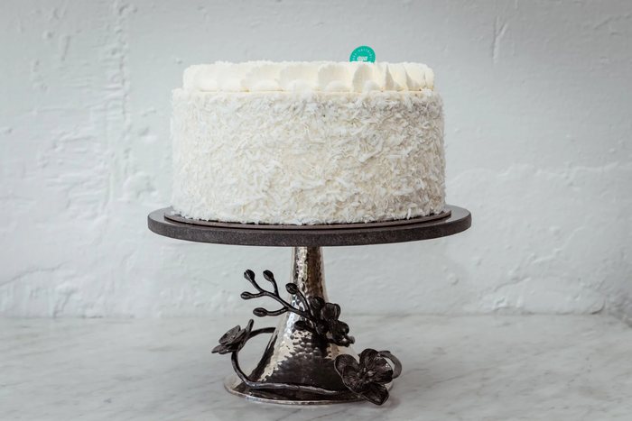 Coconut-covered cake on a cake stand