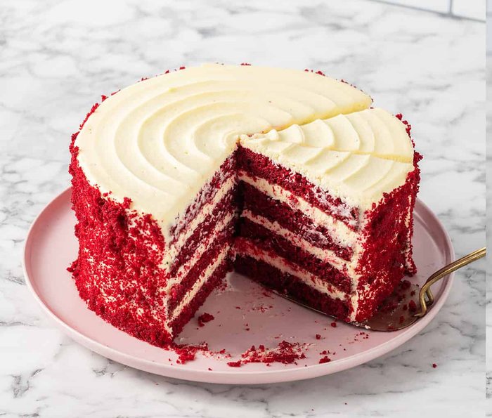 Red velvet layer cake with a slice cut out